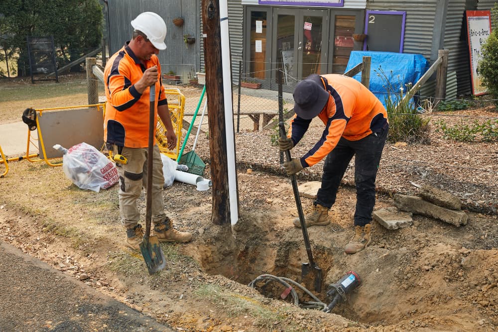 Workers using a shovel for digging